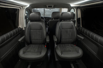 Comfortable interior of a passenger bus with soft seats. The design is made to order. Private covering of cars. Various elements of the bus interior.