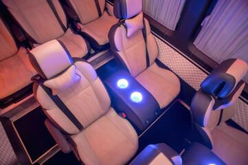 Comfortable interior of a passenger bus with soft seats. The design is made to order. Private...