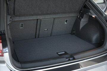 Grey soft car boot liner mat in trunk of auto