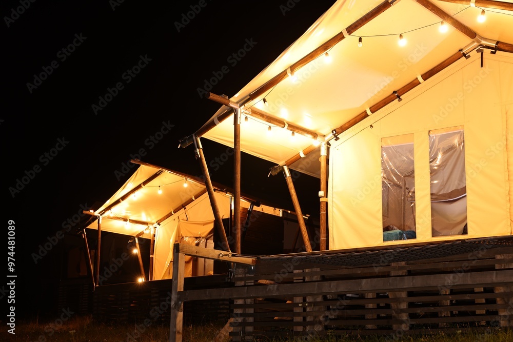 Sticker tents in mountains at night. glamping site