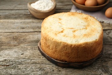 Tasty fresh sponge cake on wooden table