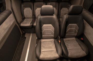 Comfortable interior of a passenger bus with soft seats. The design is made to order. Private covering of cars. Various elements of the bus interior.