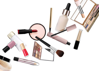 Different makeup products in air on white background