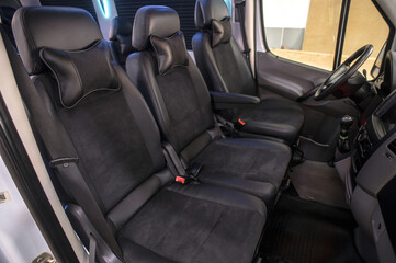 Comfortable interior of a passenger bus with soft seats. The design is made to order. Private covering of cars. Various elements of the bus interior.