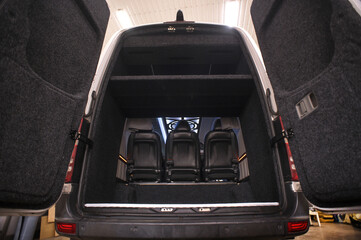 Comfortable interior of a passenger bus with soft seats. The design is made to order. Private...