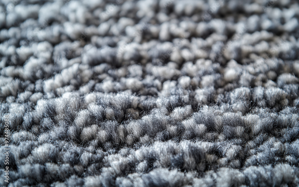 Poster close-up view of textured gray carpet fibers, showcasing the intricate weave pattern and soft materi