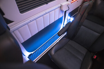Comfortable interior of a passenger bus with soft seats. The design is made to order. Private...