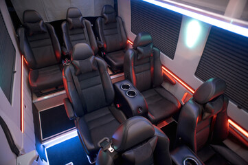 Comfortable interior of a passenger bus with soft seats. The design is made to order. Private...