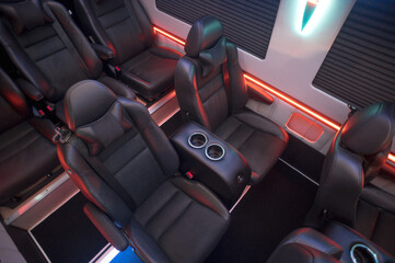 Comfortable interior of a passenger bus with soft seats. The design is made to order. Private covering of cars. Various elements of the bus interior.