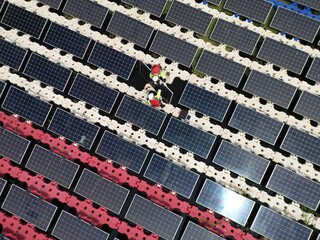Male workers repair Floating solar panels on water lake. Engineers construct on site Floating solar panels at sun light. clean energy for future living. Industrial Renewable energy of green power.