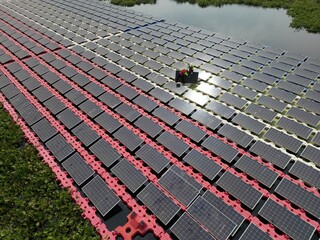 Male workers repair Floating solar panels on water lake. Engineers construct on site Floating solar panels at sun light. clean energy for future living. Industrial Renewable energy of green power.