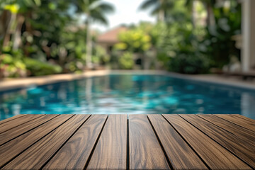 Outdoor wooden deck overlooking a tranquil swimming pool surrounded by lush greenery on a sunny day, perfect for relaxation and leisure activities.