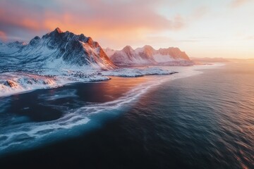 Fototapeta premium Snowy Mountain Range at Sunset Reflecting on the Sea