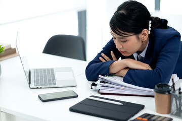 young businesswoman Wearing a suit bending over the table