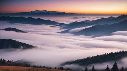 Fototapeta premium Misty mountain landscape at dawn with a pink sky.