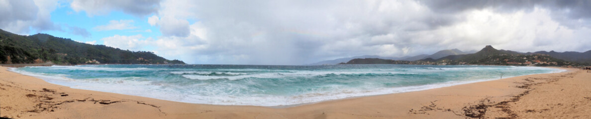 Panoramic view of Stagnone Beach in Calcatoggio, Corsica (nicknamed the Isle of Beauty), on a stormy day. This beach is a vast expanse of sand that is located north of Ajaccio, on the road to Cargese