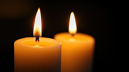 Softly lit candles against a black background, creating a tranquil scene with generous copy space for creative use