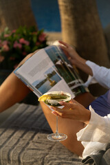 Woman Reading a Magazine by the Pool