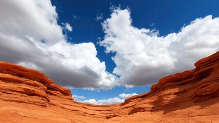 Canyon landscape with layers of red rock and stratified cliffs, under a dramatic sky filled with storm clouds