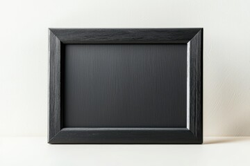 A black wooden frame with a matte finish, elegant and understated, isolated on white background