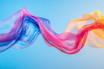 Fototapeta premium Colorful Flowing Fabric Against Blue Sky