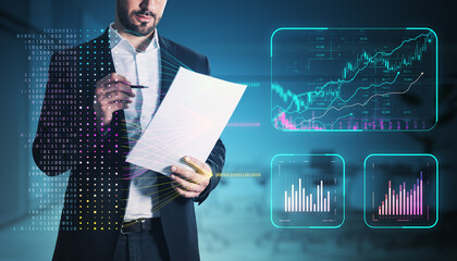 Businessman analyzing financial data with futuristic charts and graphs on a dark background.