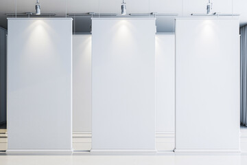 Modern gallery interior with blank white panels and overhead lighting. 3D Rendering