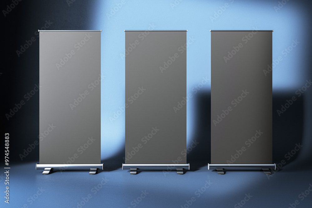 Poster three blank roll-up banners in a row on blue gradient background. 3d rendering