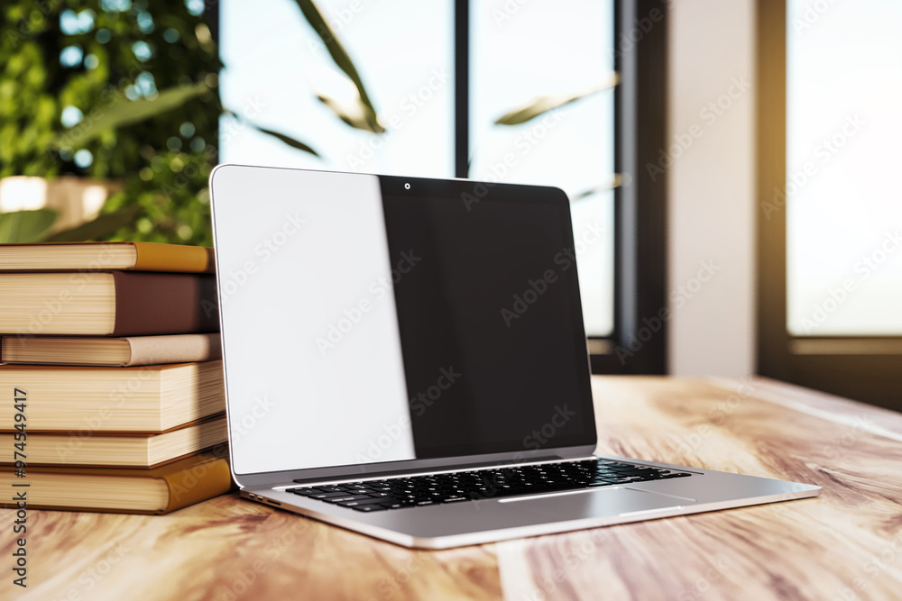 Poster laptop and stack of books on a wooden table in cozy interior. 3d rendering