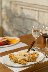Crispy turkey served on a creamy mustard sauce, elegantly plated with a crunchy garnish. A perfect balance of flavors