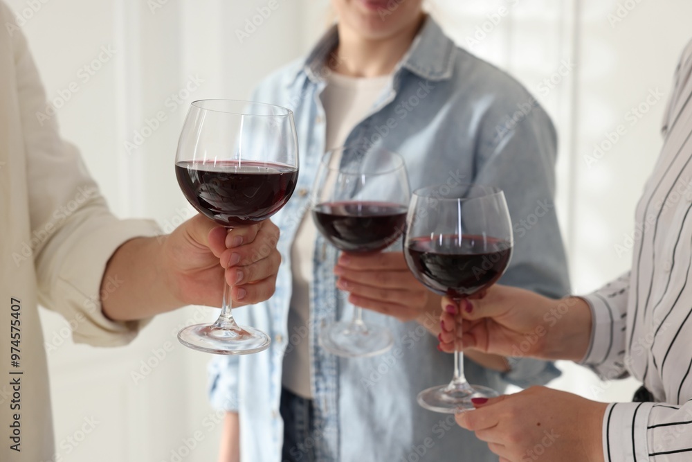 Wall mural People clinking glasses of red wine indoors, closeup