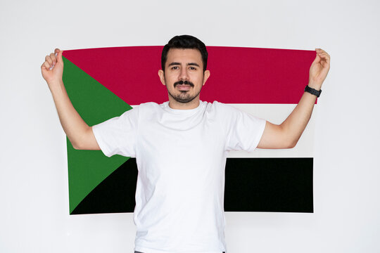 Moustached man holding Sudan flag, campaigning concept, patriot and nationalist person