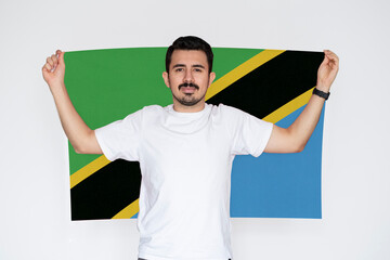 Moustached man holding Tanzania flag, protest or social issues in Tanzania, patriot and nationalist 