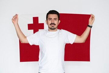 Moustached man holding Tonga flag, campaigning concept, independence or celebration day idea