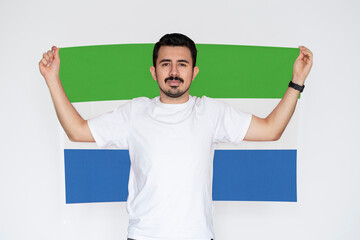 Moustached man holding Sierra Leone flag, patriot and nationalist person, independence or 