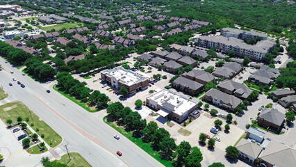Apartment complex in mixed-use development area along Keller Parkway, Farm to Market Road 1709 with commercial building, restaurants, residential houses in Keller, Texas, suburbs Dallas, aerial