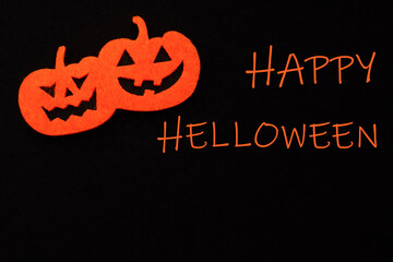 felt orange halloween pumpkin on a black background. dark background for halloween