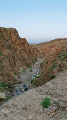 dry canyon river in the mountains between them