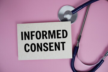 Informed Consent text with stethoscope on pink background, Healthy and wellness concept
