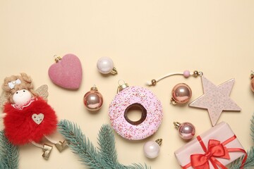 Flat lay composition with Christmas decor and gift box on beige background. Space for text