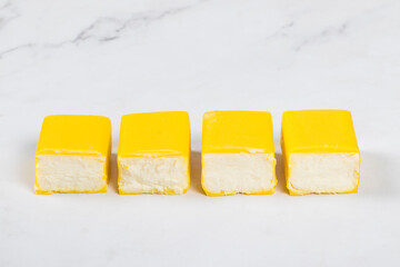 Cottage cheese dessert in lemon glaze. Close up. White background