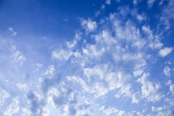 view of a bright blue sky accompanied by clouds