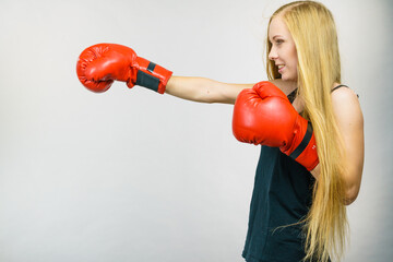 Woman in red gloves boxing