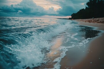 Ocean Waves Crashing on a Sandy Beach at Sunset