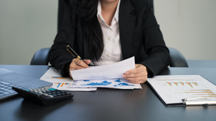 Businesswomen using the pen and calculator tax online return form for payment, Accounting financial...