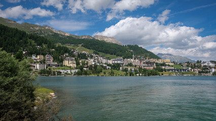 The mountain lake of St. Moritz with the fashionable alpine resort in the background on a nice summer day