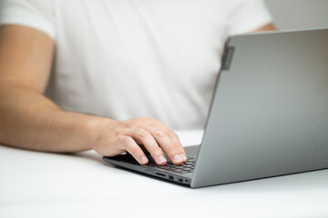 Close up of young man using laptop