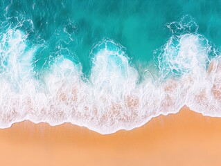 Aerial view of clear turquoise waves gently crashing on a sandy beach, showcasing the beauty of nature and serenity.