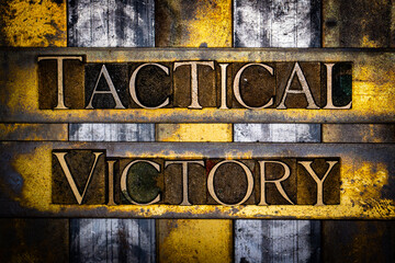 Tactical Victory text in real authentic typeset letters on vintage textured silver grunge copper and gold background