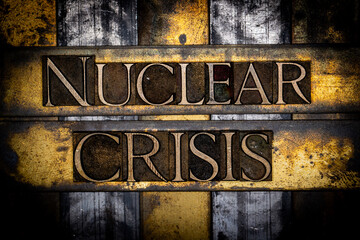 Nuclear Crisis text in real authentic typeset letters on vintage textured silver grunge copper and gold background